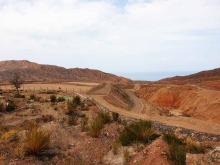 On the left: area that has been levelled in the course of remediation; Lake Issyk-Kul is visible in the background. 